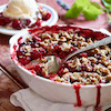 Cherry cobbler in dish with serving spoon